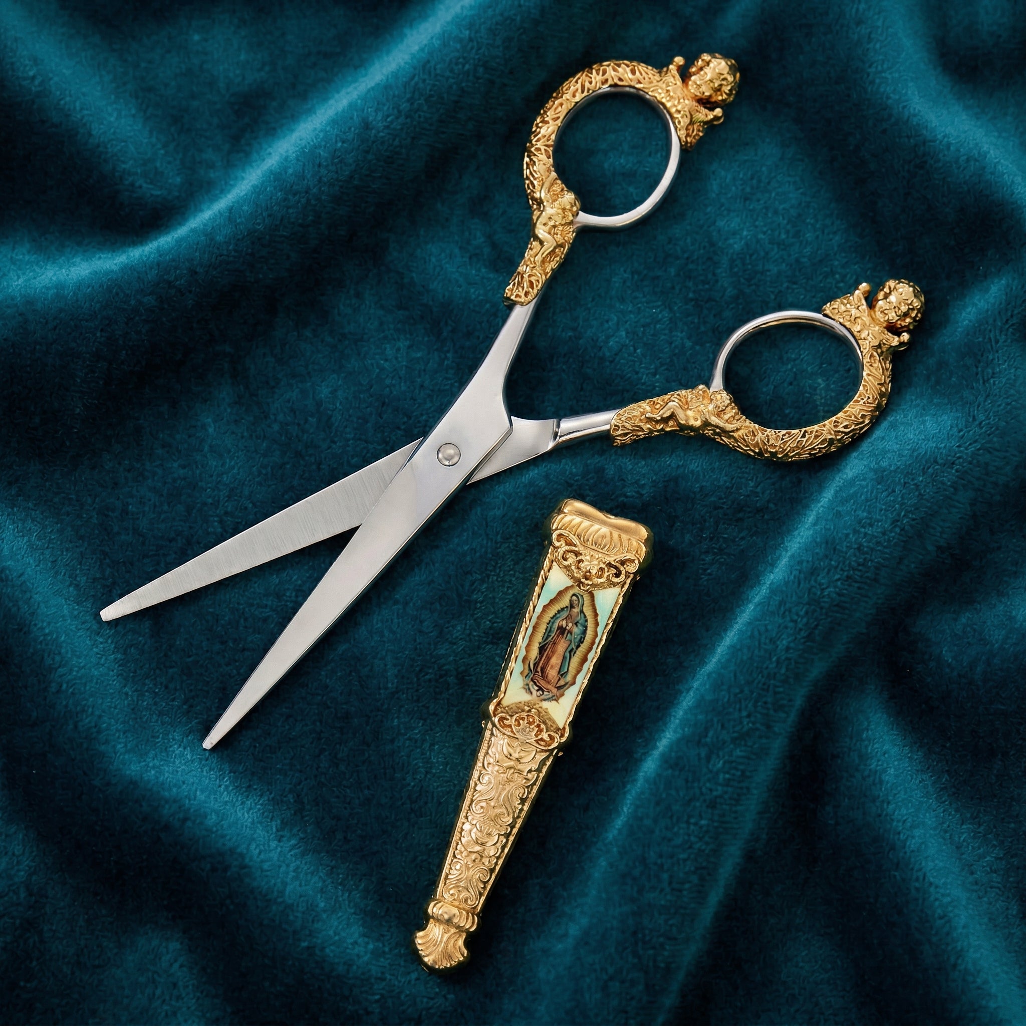 Decorative scissors with gold handles on a blue fabric background