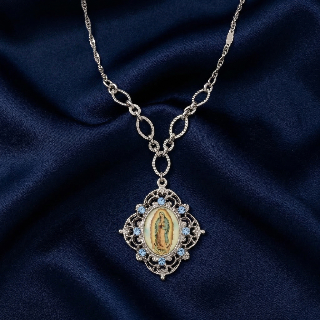 Silver necklace with a religious pendant featuring an image on a dark blue fabric background