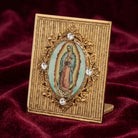 Decorative table decor with a religious icon, Our Lady of Guadalupe on a red fabric background