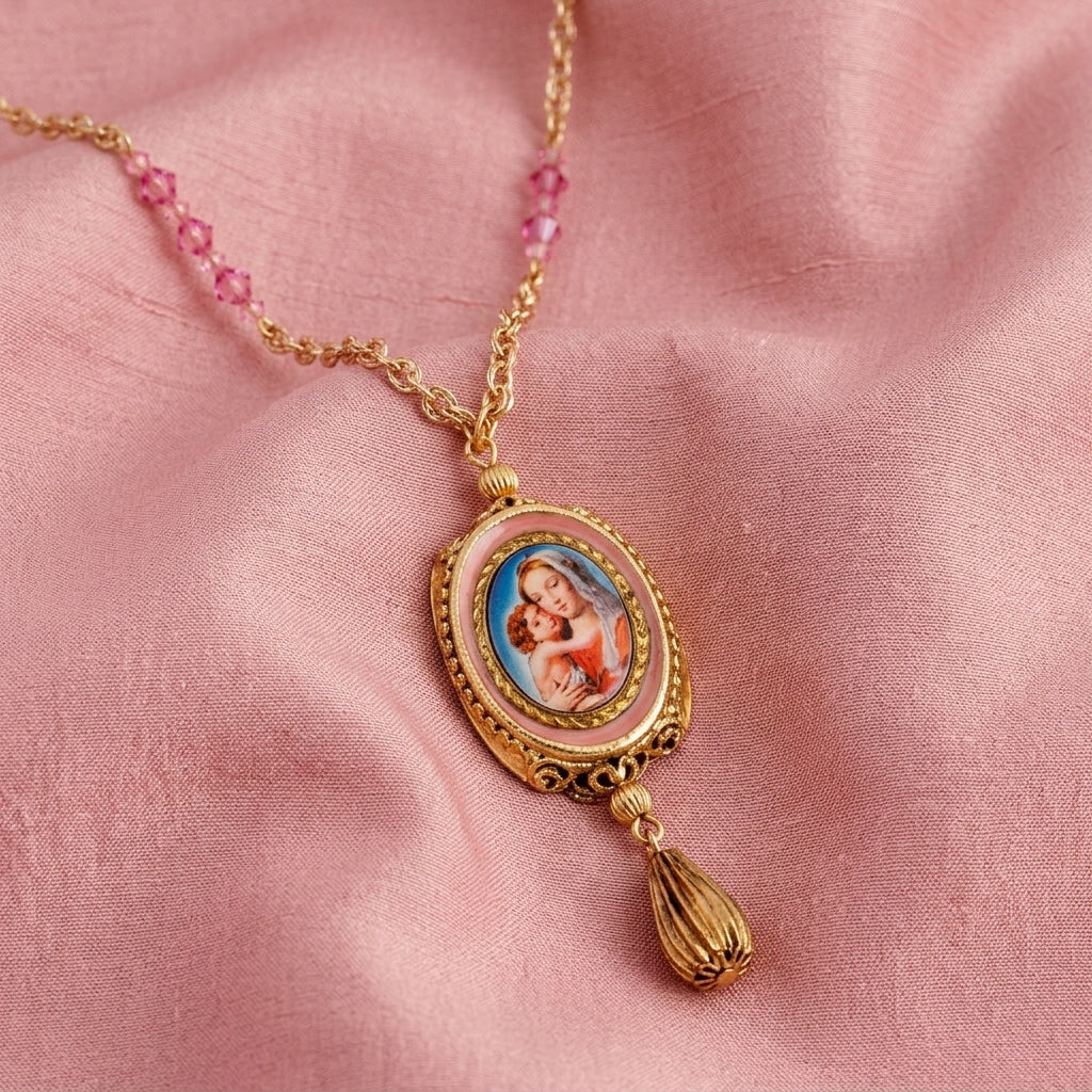 Gold necklace with a spinner pendant and pink glass beads featuring a religious scene on a pink fabric background