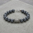Black Faux Pearl & Prayer Bead Bracelet on cement