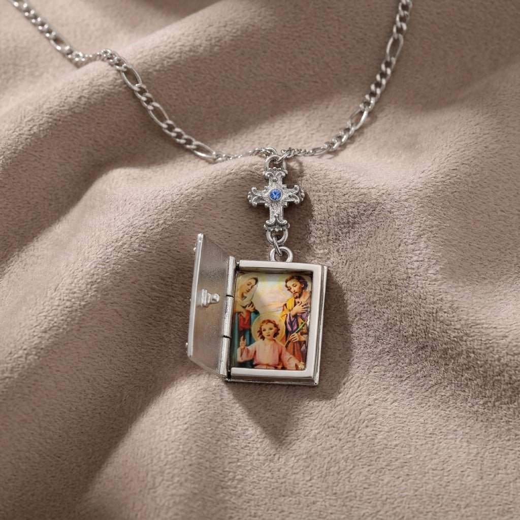 Necklace with a locket pendant featuring religious imagery on beige fabric