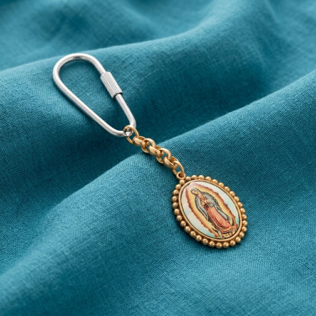 Decorative keychain with Our Lady of Guadalupe design on a blue fabric background