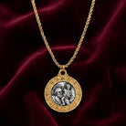Gold tone necklace with a pendant featuring St. Christopher on a red velvet background