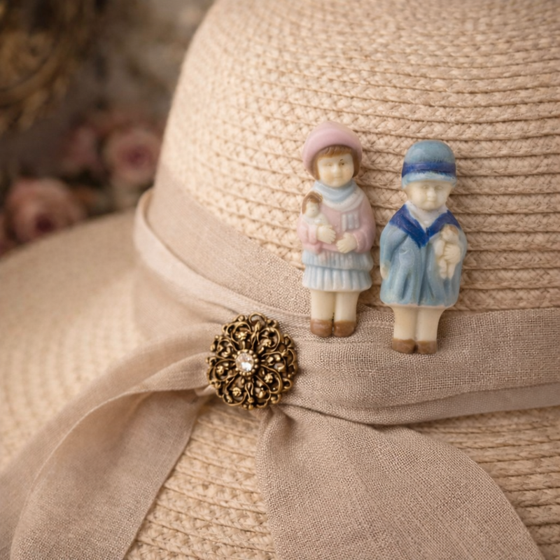 Delicate porcelain doll hat pins on a nicely knitted hat.